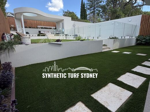 Synthetic turf laid around pavers and stepping stones