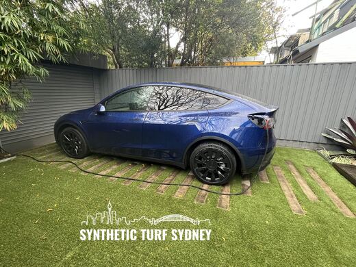 Synthetic turf laid around pavers and stepping stones