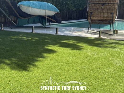 Synthetic turf laid around a swimming pool