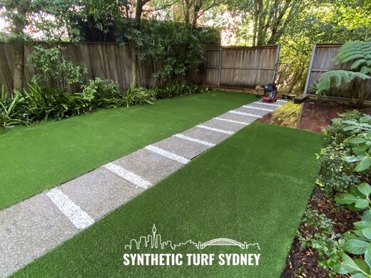 Synthetic turf laid around pavers and stepping stones