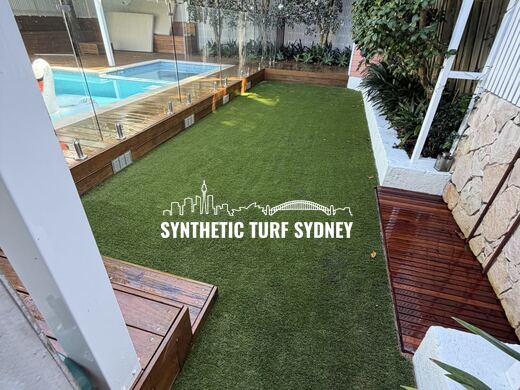 Lawn beside a fenced pool and deck, laid in Collaroy 40mm synthetic turf
