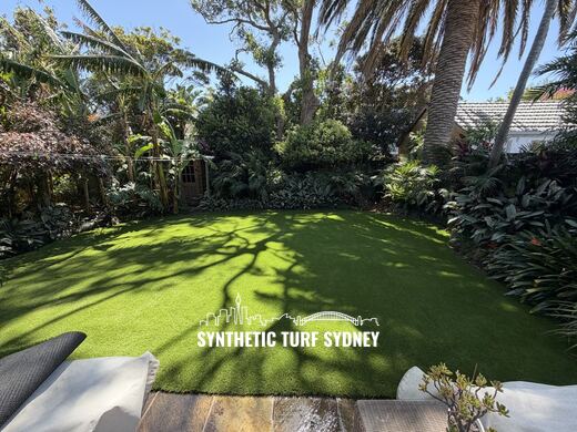 Shaded lawn under a palm canopy, laid in Collaroy 40mm synthetic turf