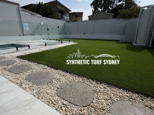 Lawn and pebble border beside a pool, laid in Collaroy 40mm synthetic turf