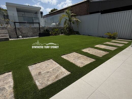 Paver path across a courtyard lawn, laid in STS Commercial synthetic turf