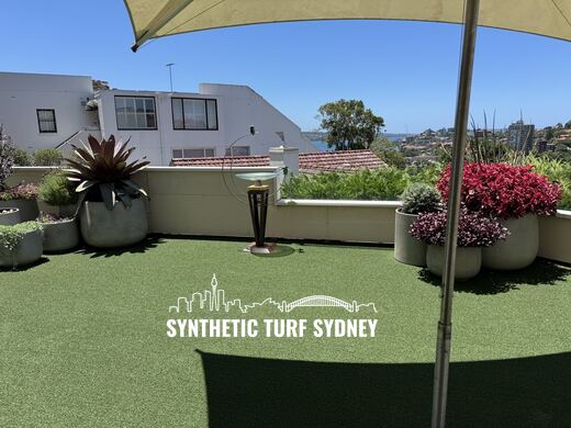 Rooftop terrace under a shade sail, laid in STS Commercial synthetic turf