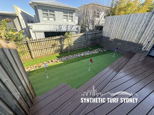Putting green beside a timber deck, laid in STS Putting Turf synthetic turf