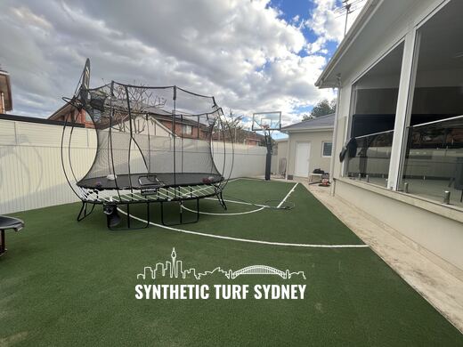 Marked half court beside a glass wall, laid in STS Commercial synthetic turf