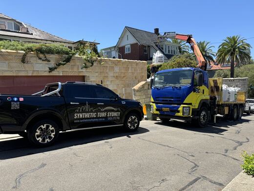 Crane lift over a sandstone wall, laid in STS Commercial synthetic turf