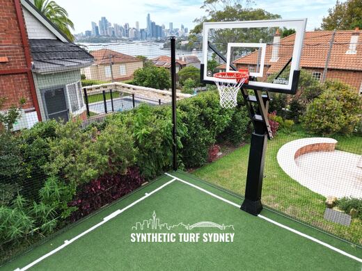Crane lift over a sandstone wall, laid in STS Commercial synthetic turf