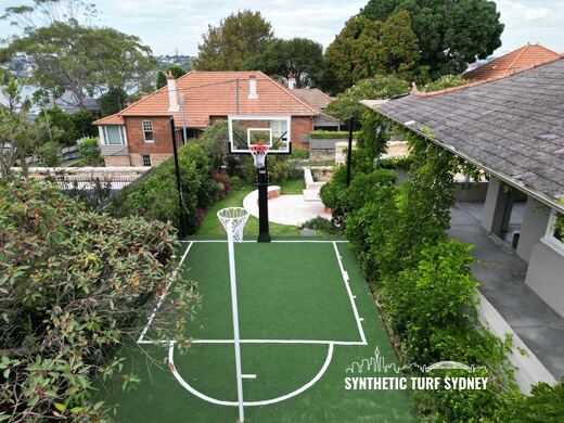 Crane lift over a sandstone wall, laid in STS Commercial synthetic turf