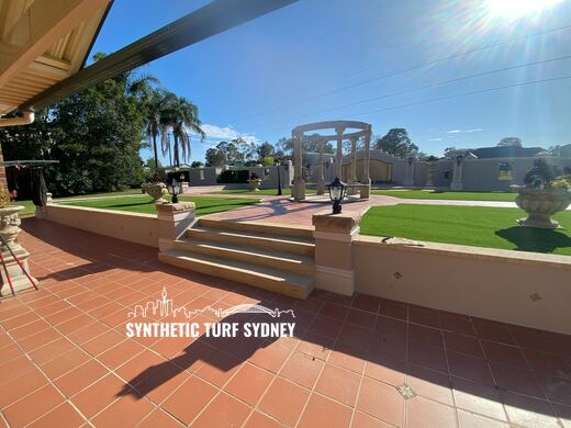 Formal lawn beyond a tiled terrace, laid in Collaroy 40mm synthetic turf