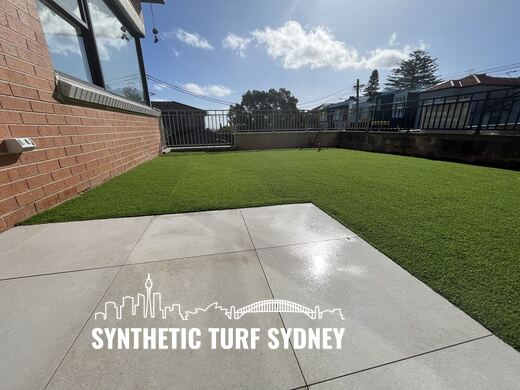 Raised lawn beside a concrete drive, laid in Collaroy 40mm synthetic turf