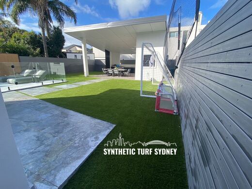 Lawn between a pool and a carport, laid in Hyde Park 40mm synthetic turf