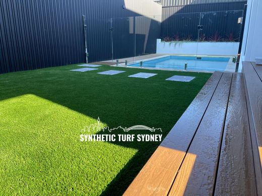 Synthetic turf laid around a swimming pool