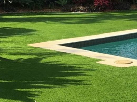 Synthetic turf laid around a swimming pool