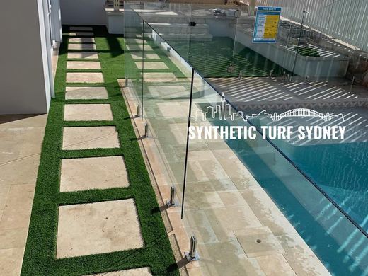Synthetic turf laid around a swimming pool