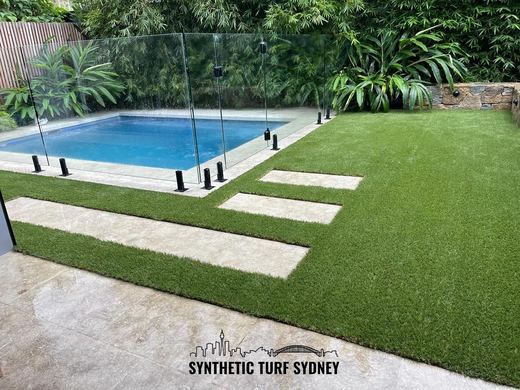 Synthetic turf laid around a swimming pool