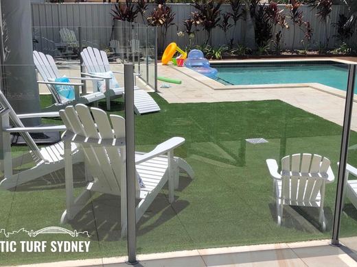 Synthetic turf laid around a swimming pool