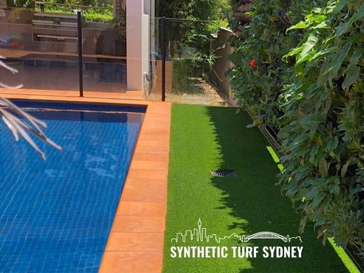 Synthetic turf laid around a swimming pool