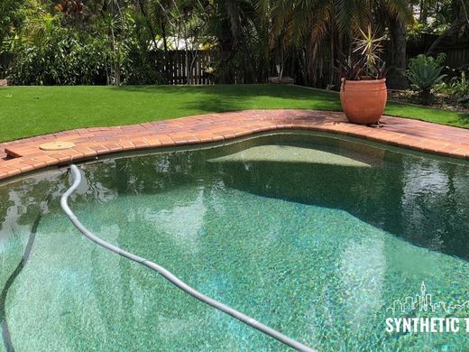 Synthetic turf laid around a swimming pool