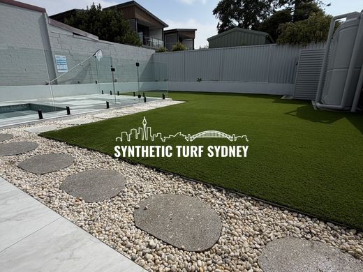Synthetic turf laid around pavers and stepping stones