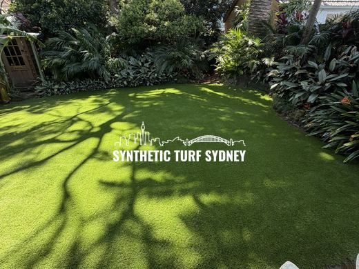 Shaded lawn under a palm canopy, laid in Collaroy 40mm synthetic turf