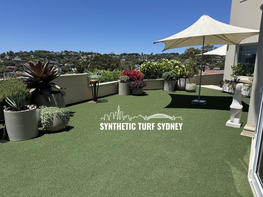 Rooftop terrace under a shade sail, laid in STS Commercial synthetic turf