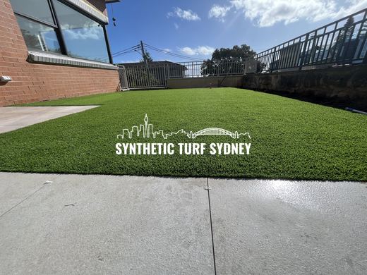 Raised lawn beside a concrete drive, laid in Collaroy 40mm synthetic turf